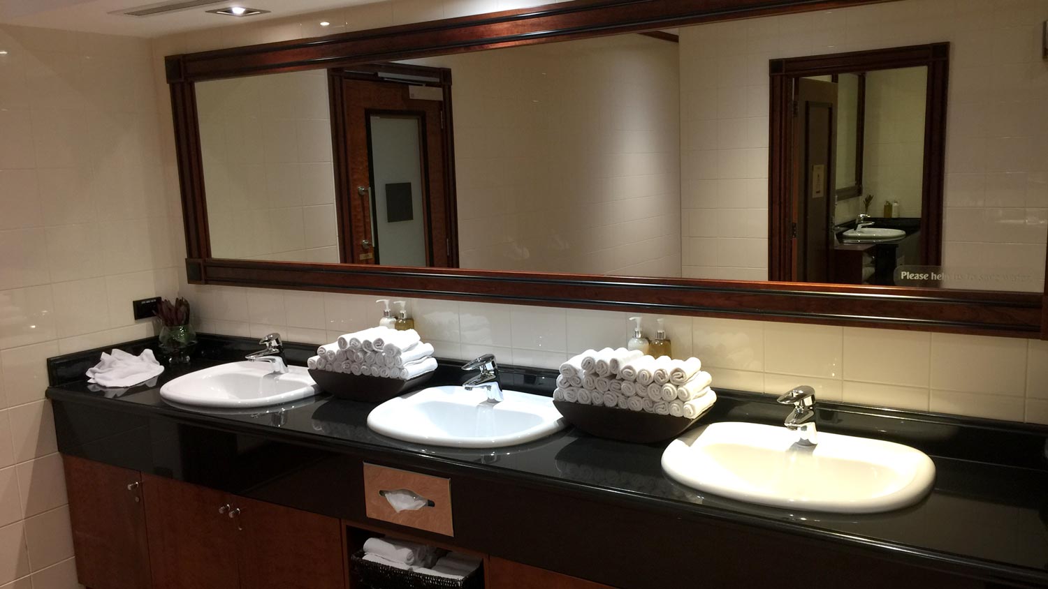 a bathroom with sinks and towels