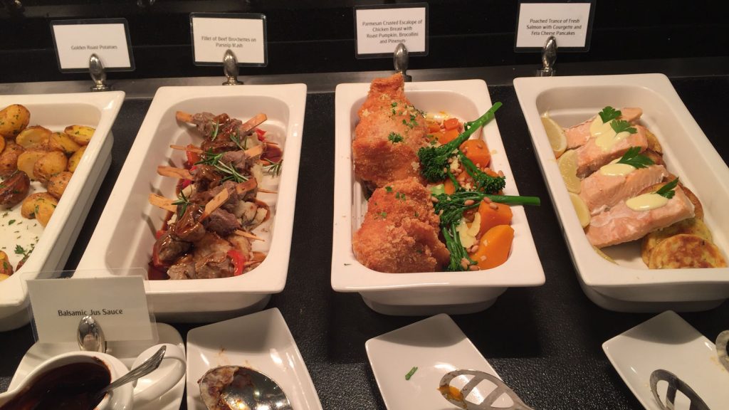 a group of white rectangular containers with food on them