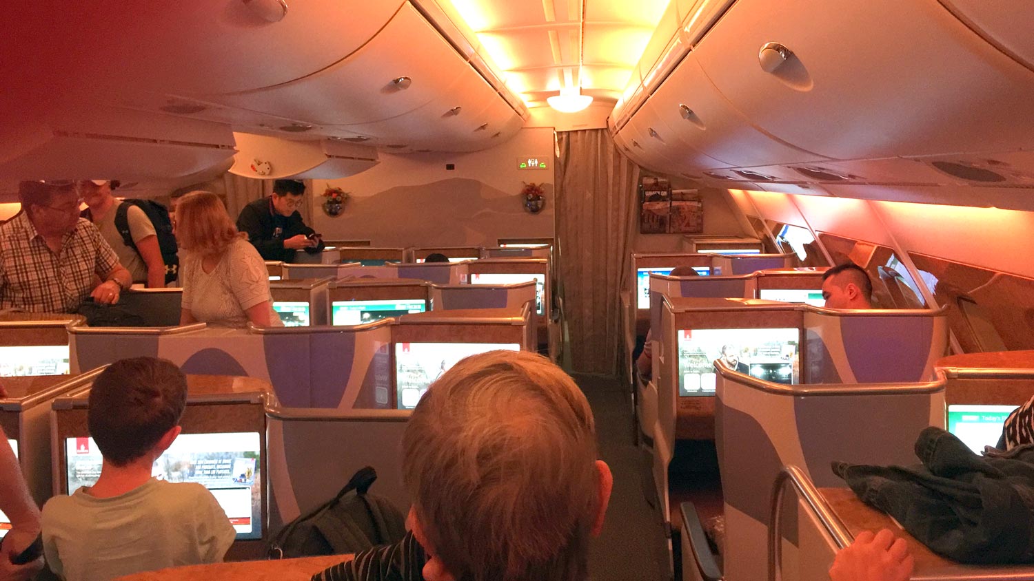 people inside a plane with people sitting in chairs