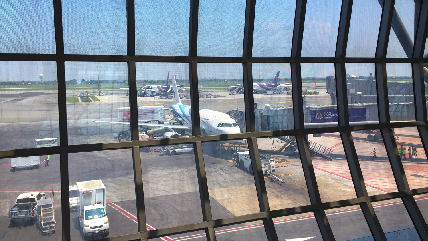 a window of an airport with airplanes