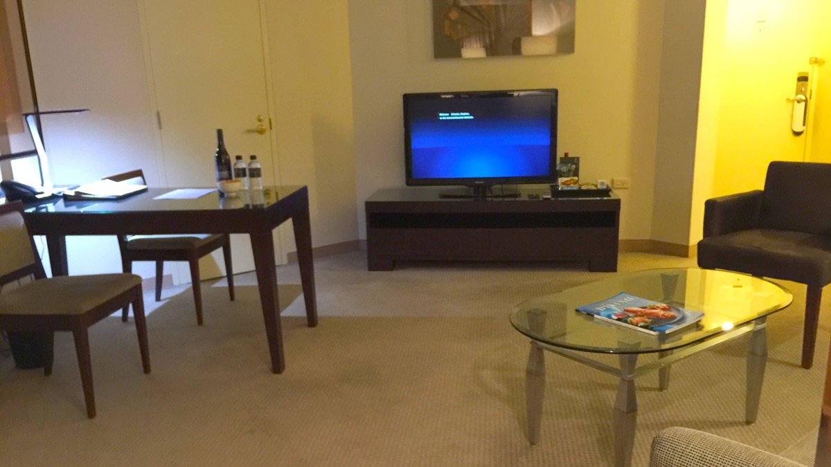 a living room with a television and a table