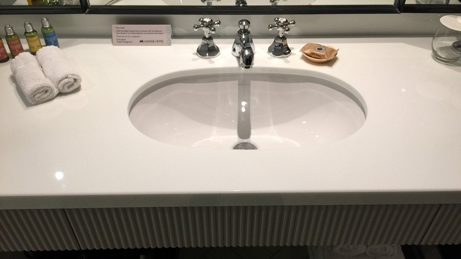 a sink with faucets and a mirror