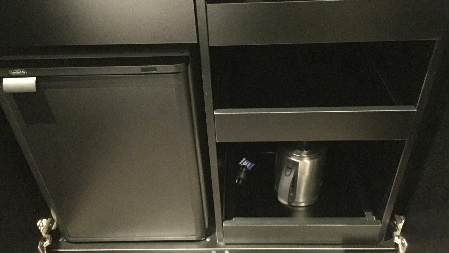 a black cabinet with a silver container