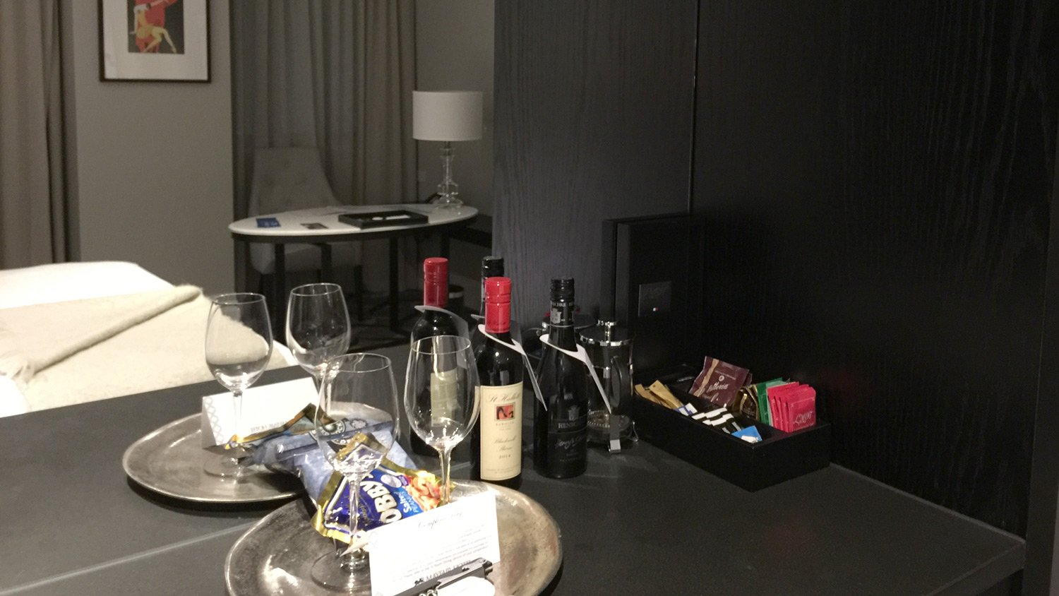 a table with wine bottles and snacks