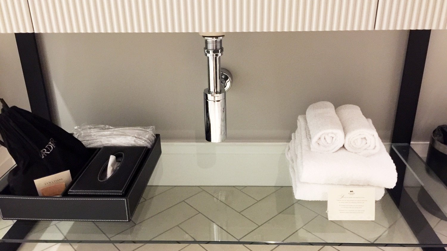 a bathroom sink with a silver faucet and white towels
