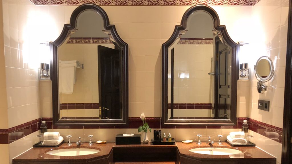 a bathroom with two mirrors