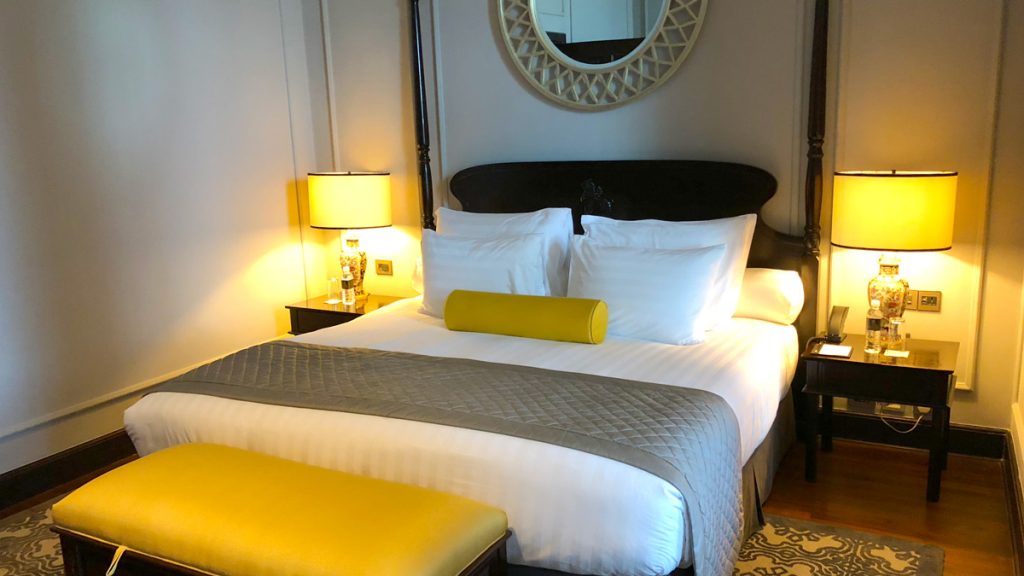 a bed with a yellow pillow