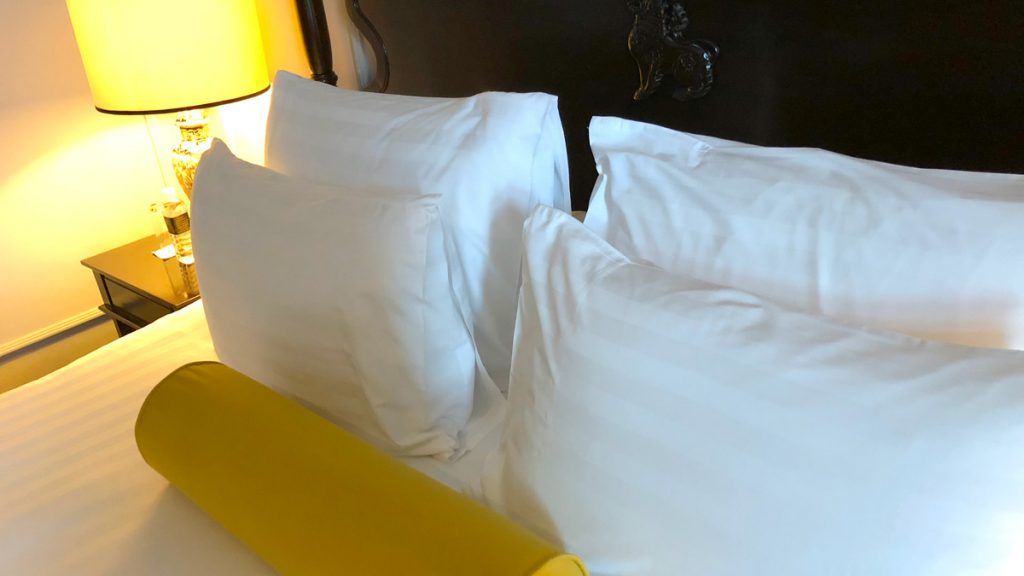 a bed with white pillows