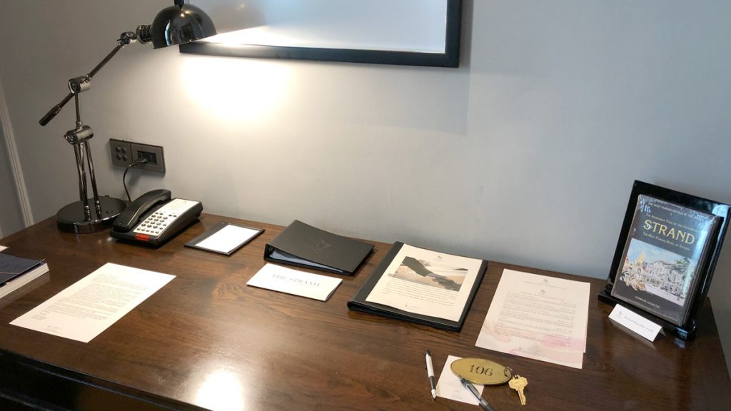 a desk with papers and a phone