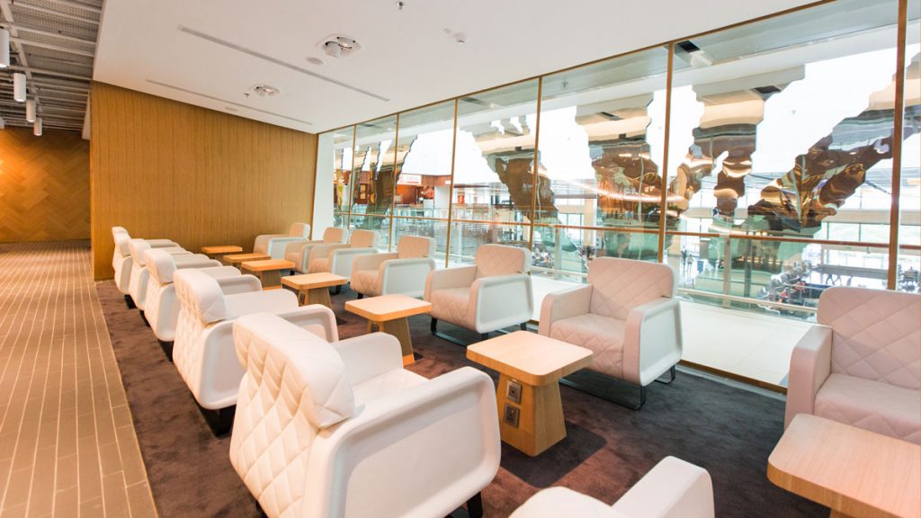 a room with white chairs and tables