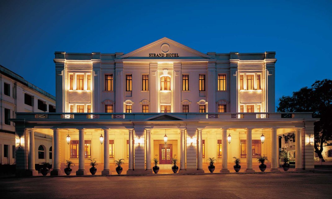 a large white building with columns and lights