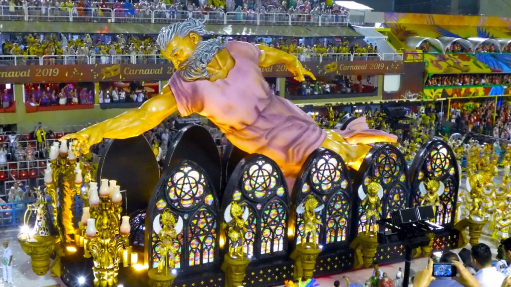 a large statue of a man on a float in a stadium