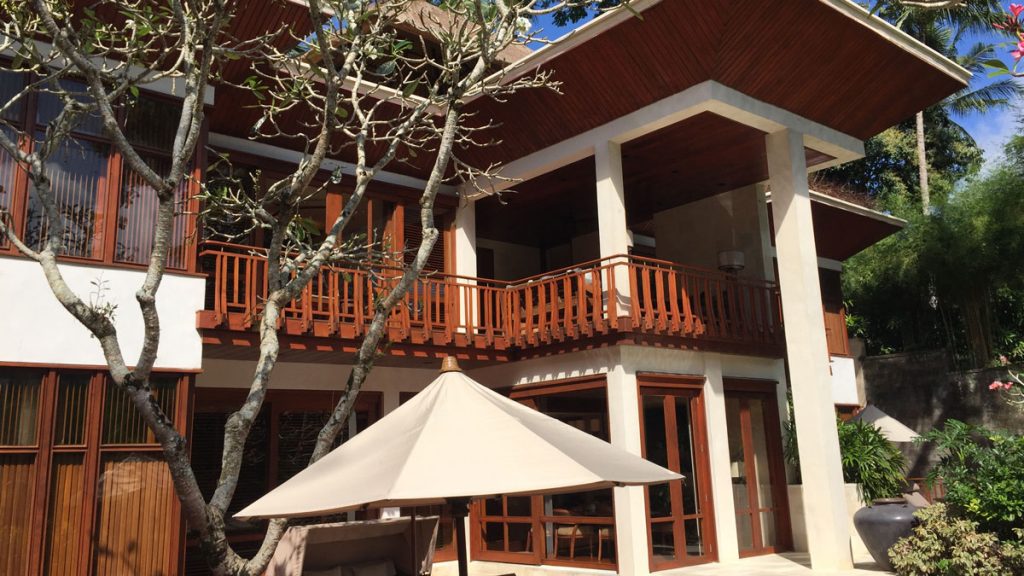 a building with a balcony and a tree