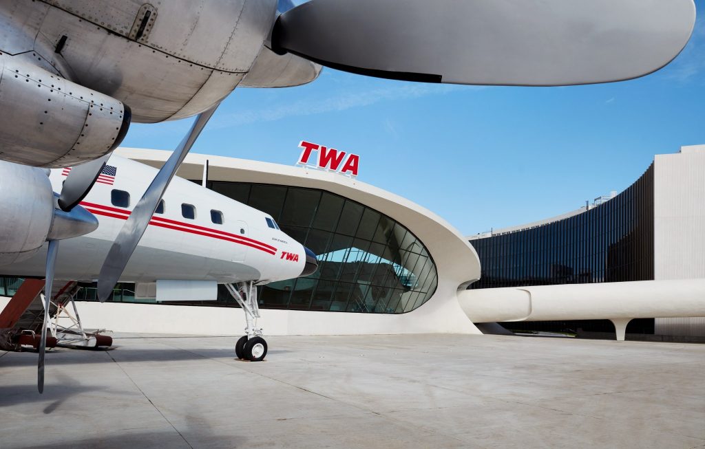 a plane parked outside of a building