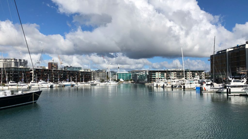 a body of water with boats and buildings in the background