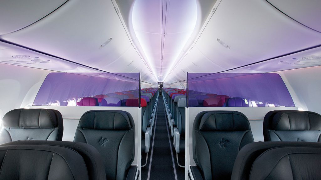 the inside of an airplane with rows of seats