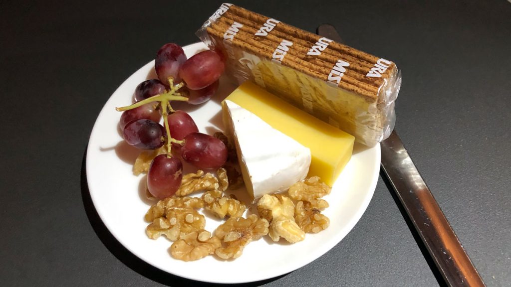 a plate of cheese grapes and crackers