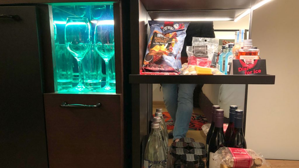 a shelf with wine glasses and snacks