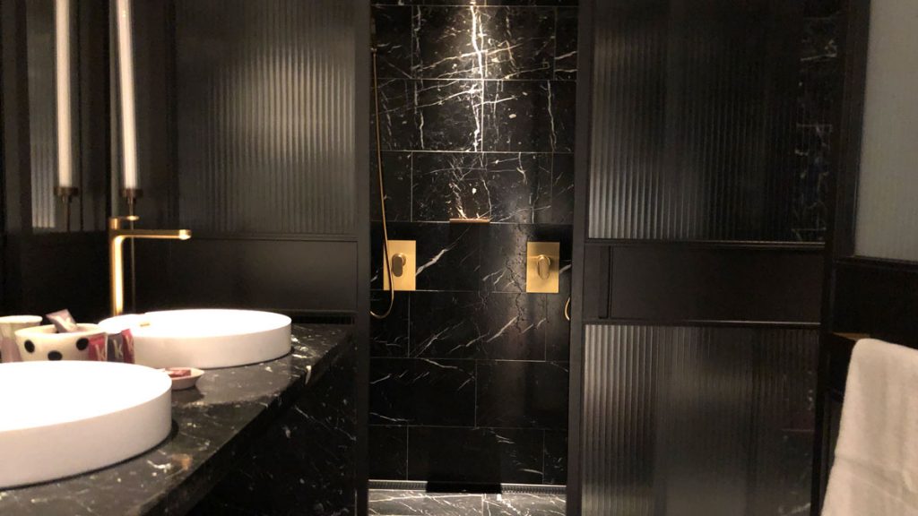 a black and white bathroom with a sink and a black counter