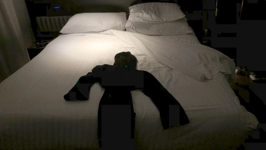 a black jacket on a bed