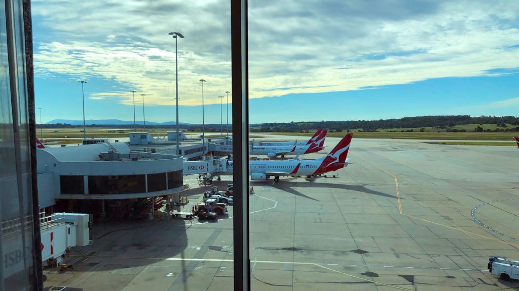 a group of airplanes parked at an airport