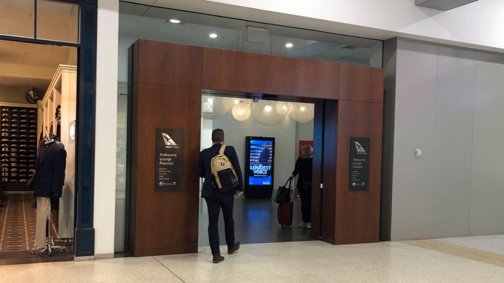 a man and woman walking into an elevator