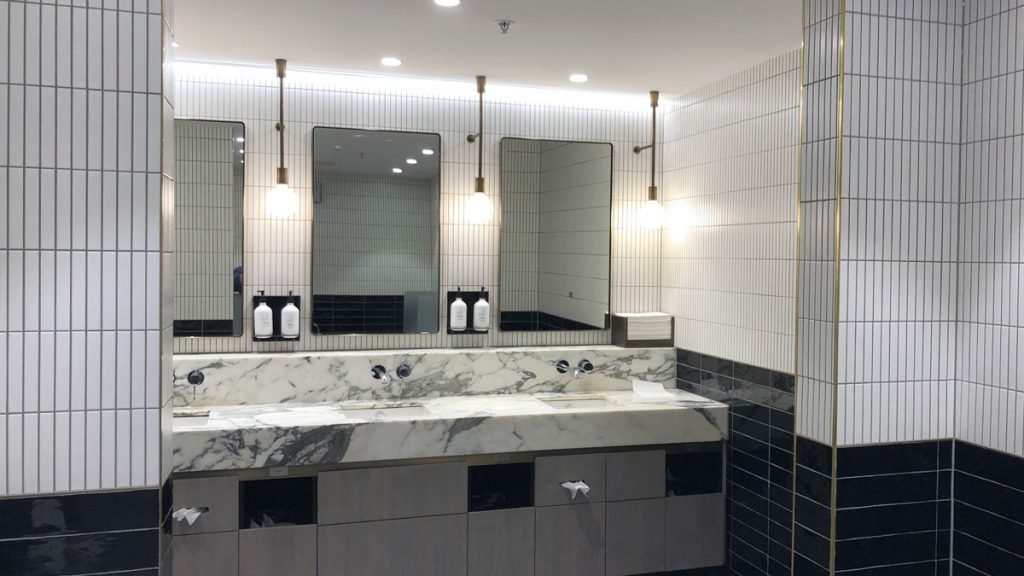 a bathroom with a marble countertop and mirrors