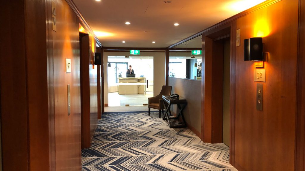 a hallway with a man standing behind the counter