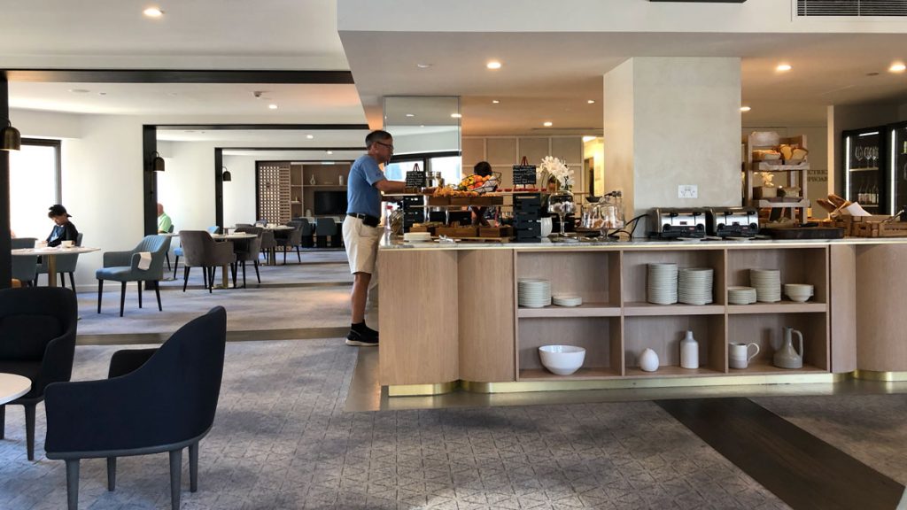 a man standing in a room with a buffet