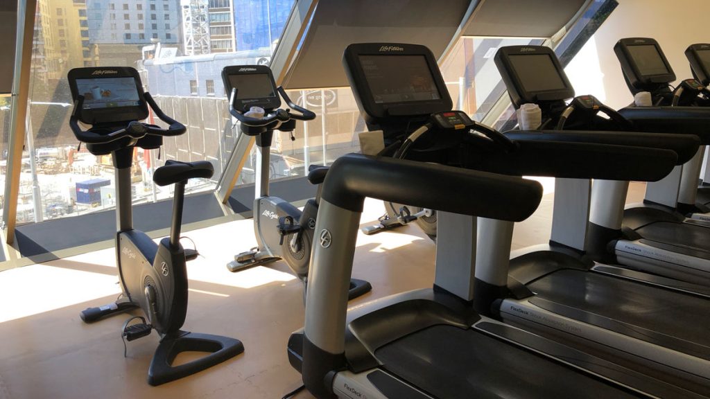 a group of exercise bikes in a gym