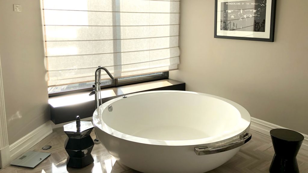 a large white bathtub in a bathroom