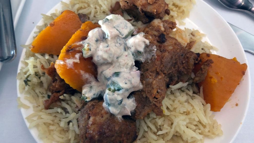 a plate of food with rice and meat