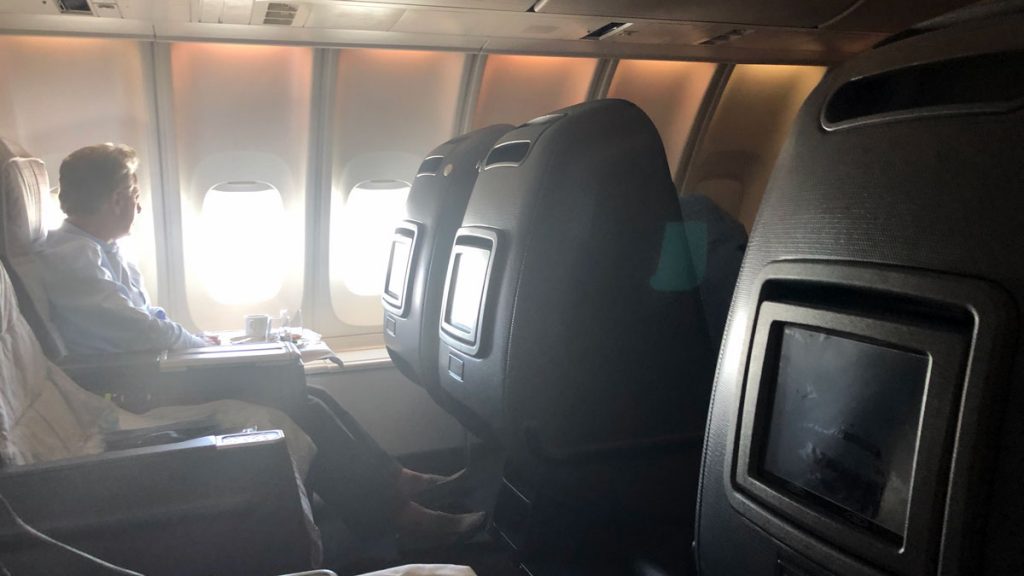 seats in an airplane with a television on the side