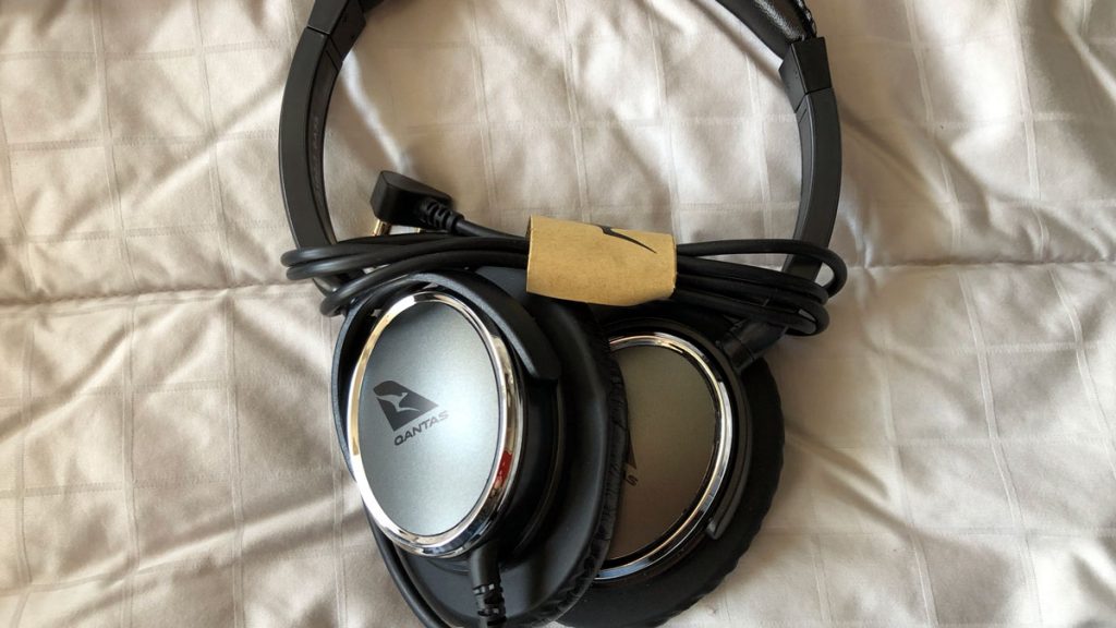 a pair of headphones on a bed