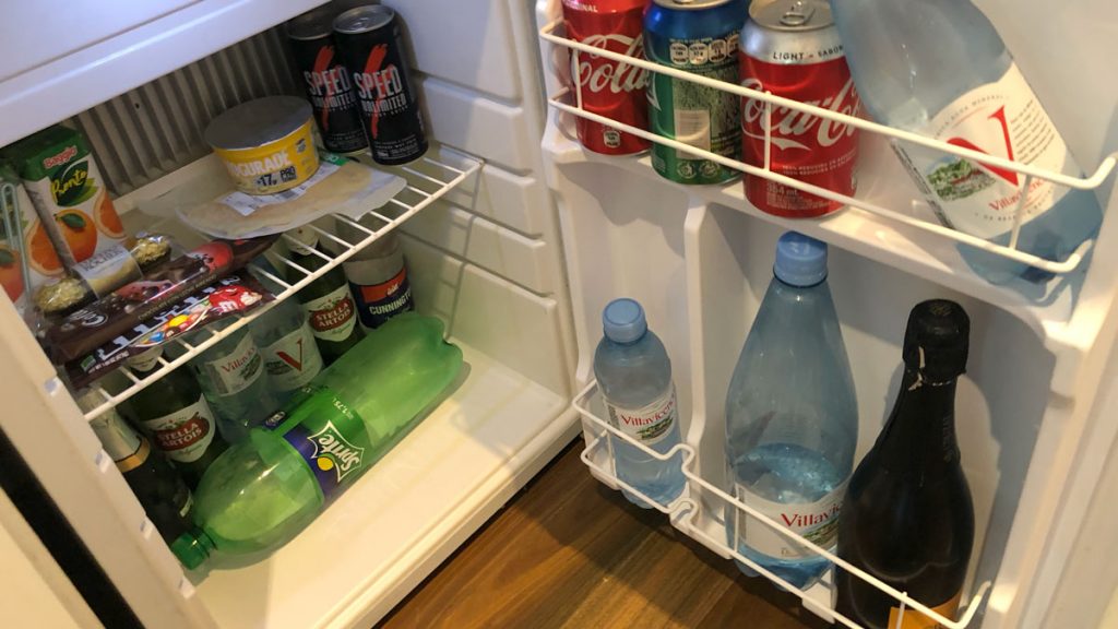 a refrigerator with drinks and cans