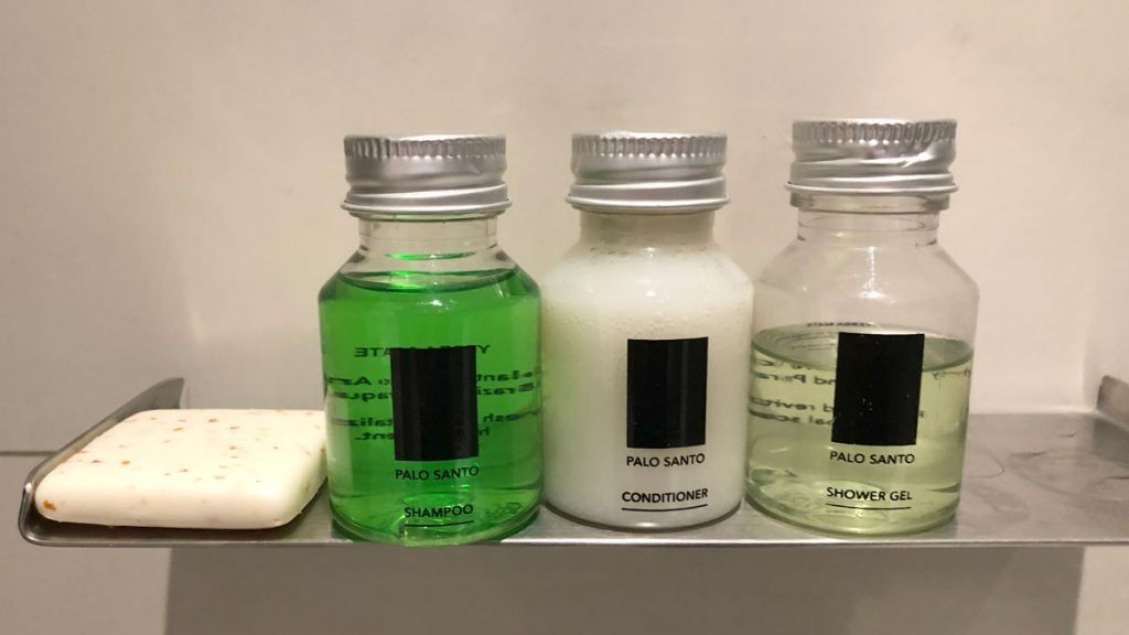 a group of bottles with green liquid and white liquid