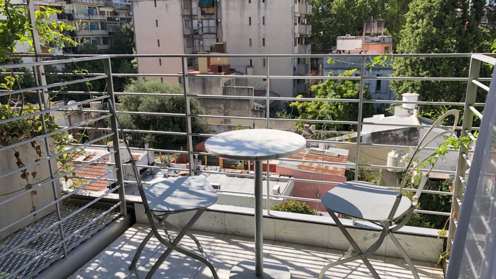 a table and chairs on a balcony