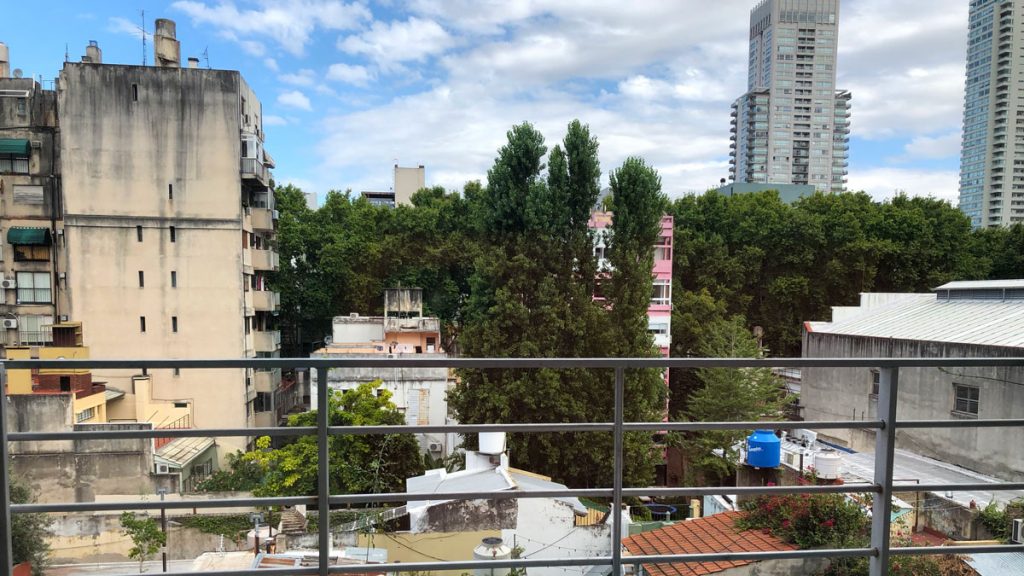 a balcony with trees and buildings