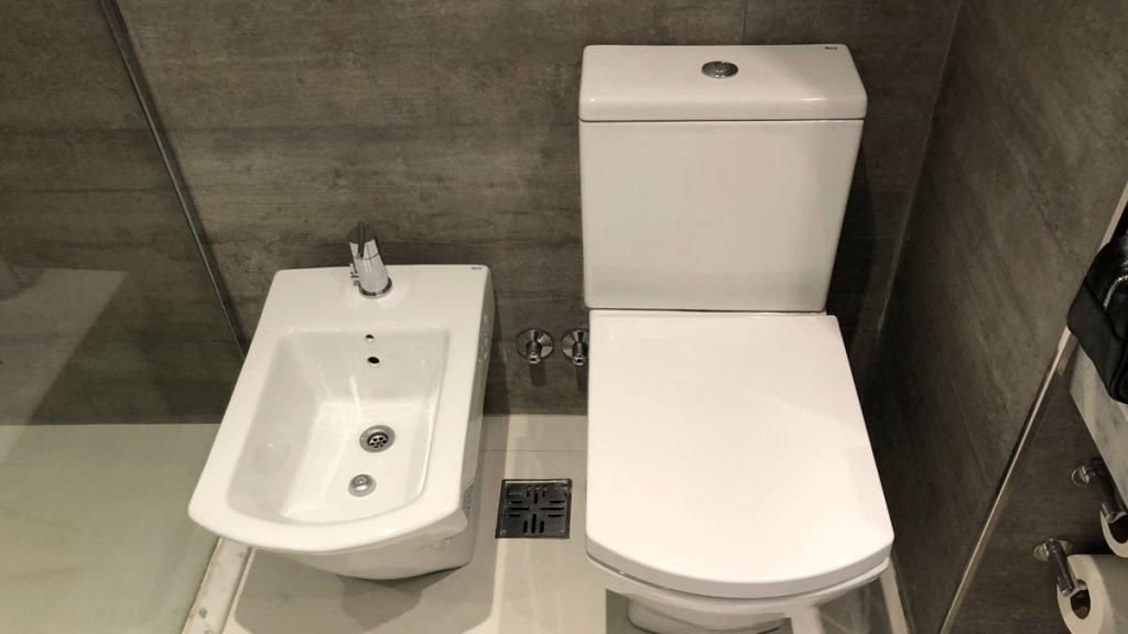 a toilet and bidet in a bathroom