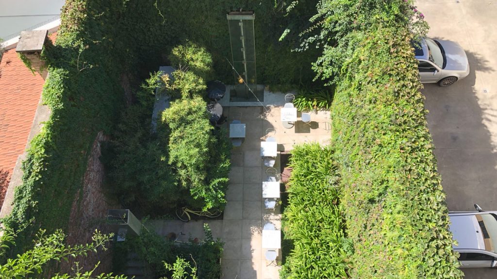 a patio area with tables and chairs