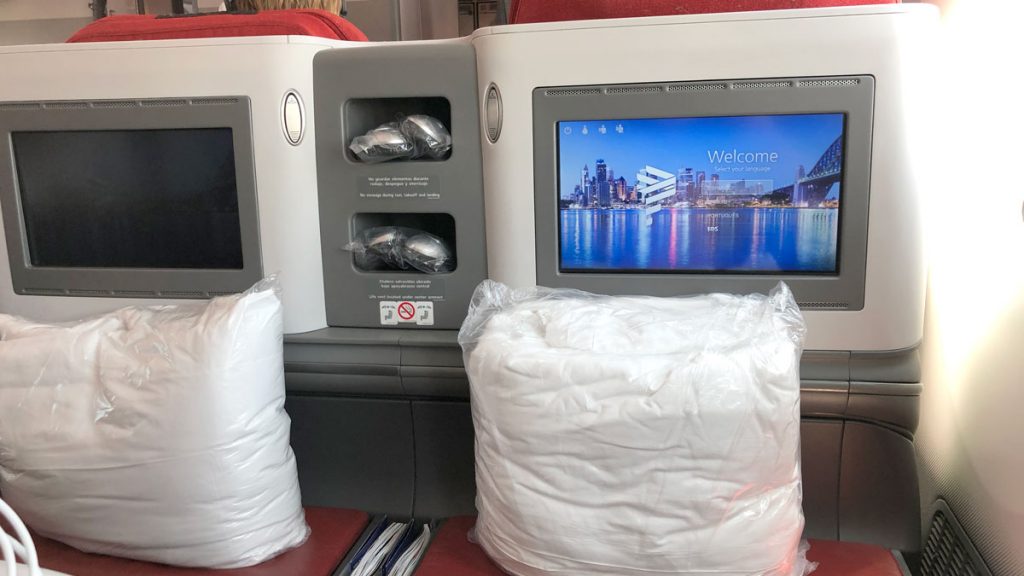 a white bags of pillows on a seat