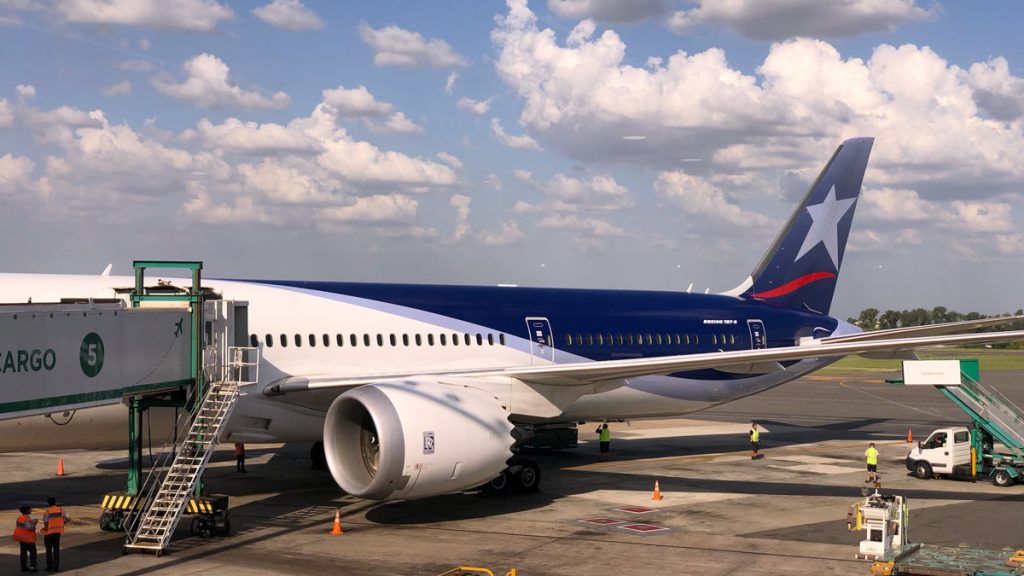 a blue and white airplane on a runway