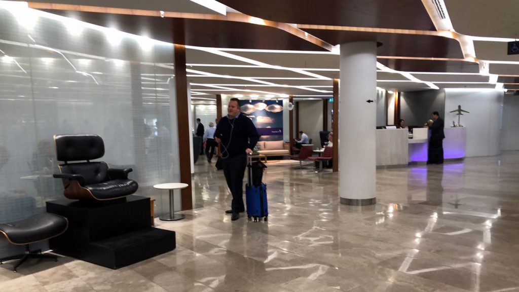 a man pulling a luggage bag in a lobby