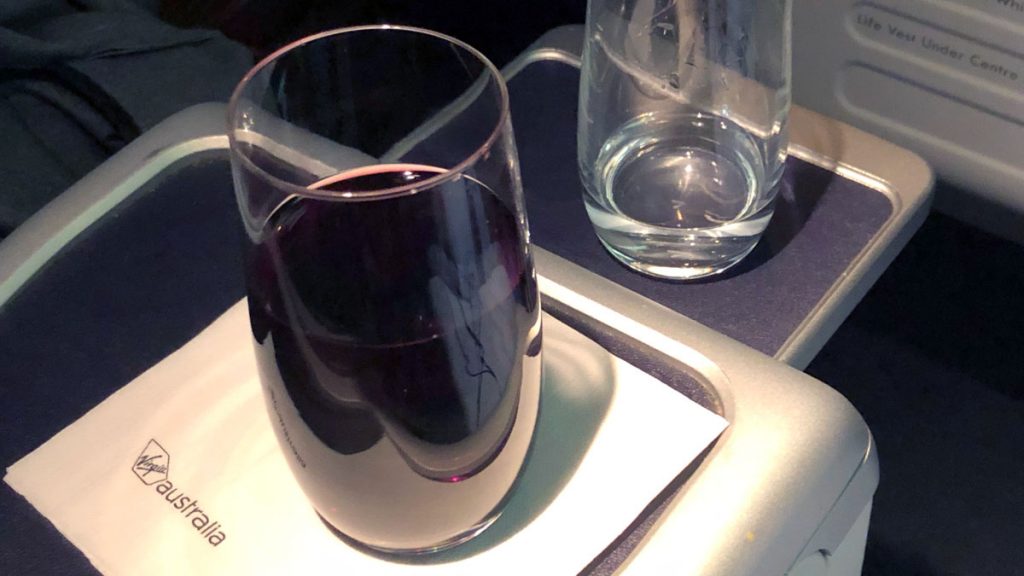 a glass of wine on a tray