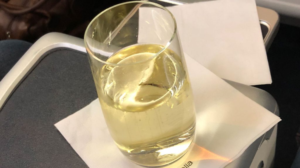 a glass of liquid on a napkin