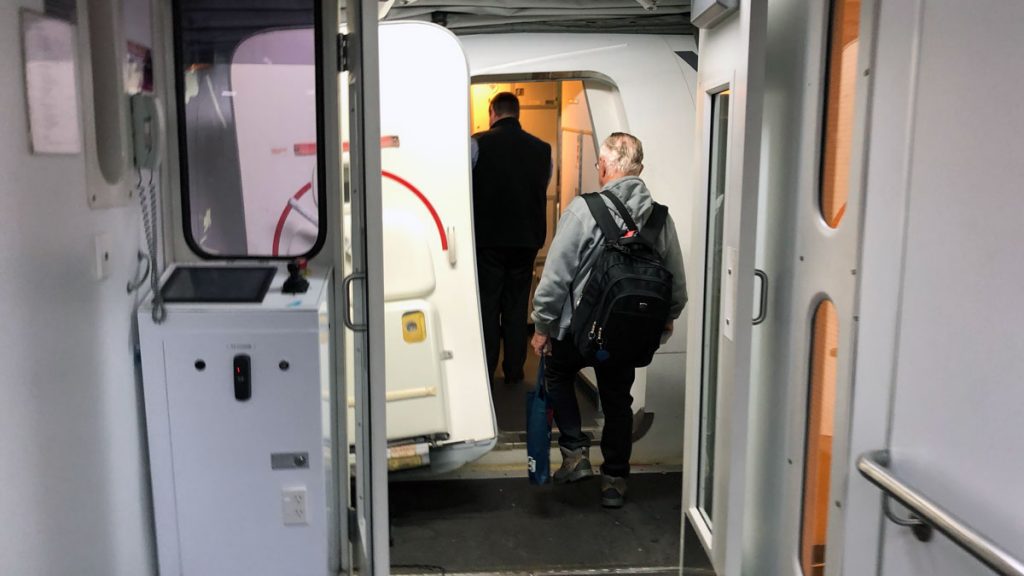 a man walking into a white vehicle