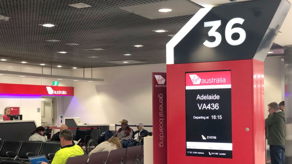 a group of people sitting in chairs in a terminal