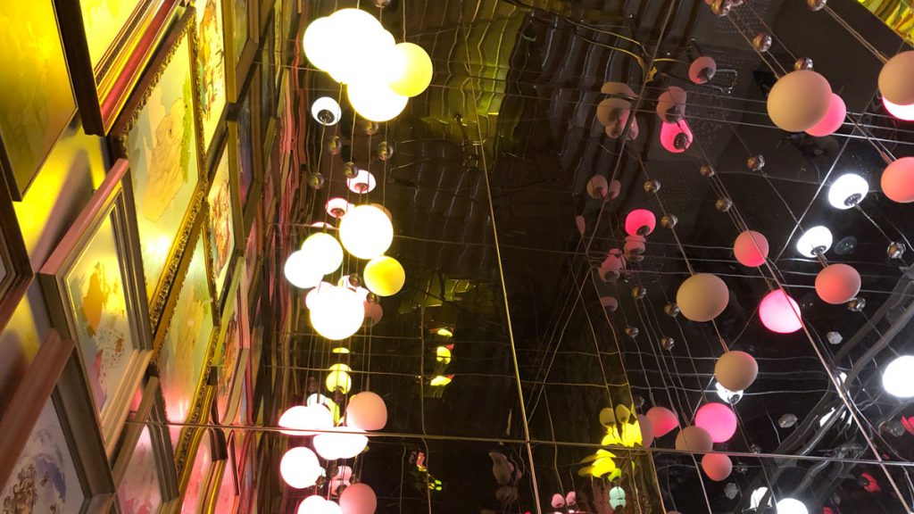 a mirror wall with lights and balloons