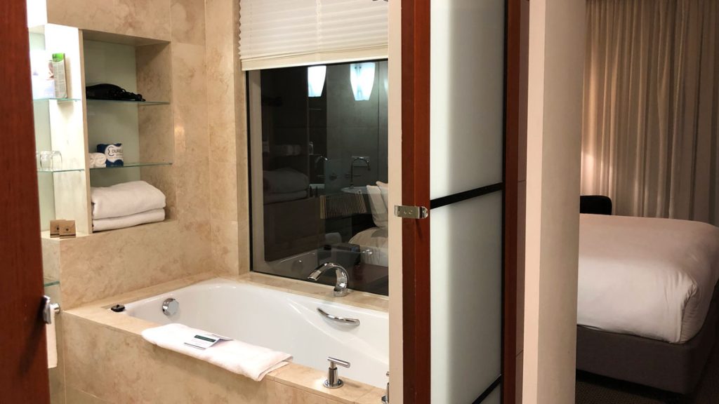 a bathroom with a bathtub and a window