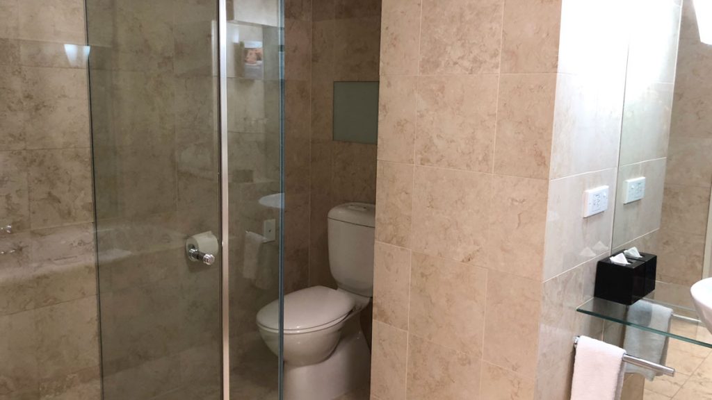 a bathroom with a glass shower door